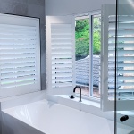 Plantation shutters are being displayed in a Sydney home installation done by Unique Blinds. The service area was a bathroom with the blinds situated above the bath tub.