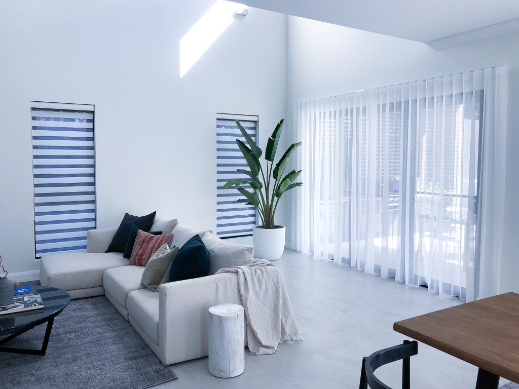 A Zebra blinds installation is being displayed with a neutral colour scheme in a living room to depict unique blinds in Sydney homes.